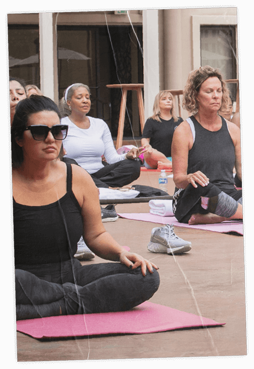 Group practicing morning yoga during an iconic.23 morning wellness session